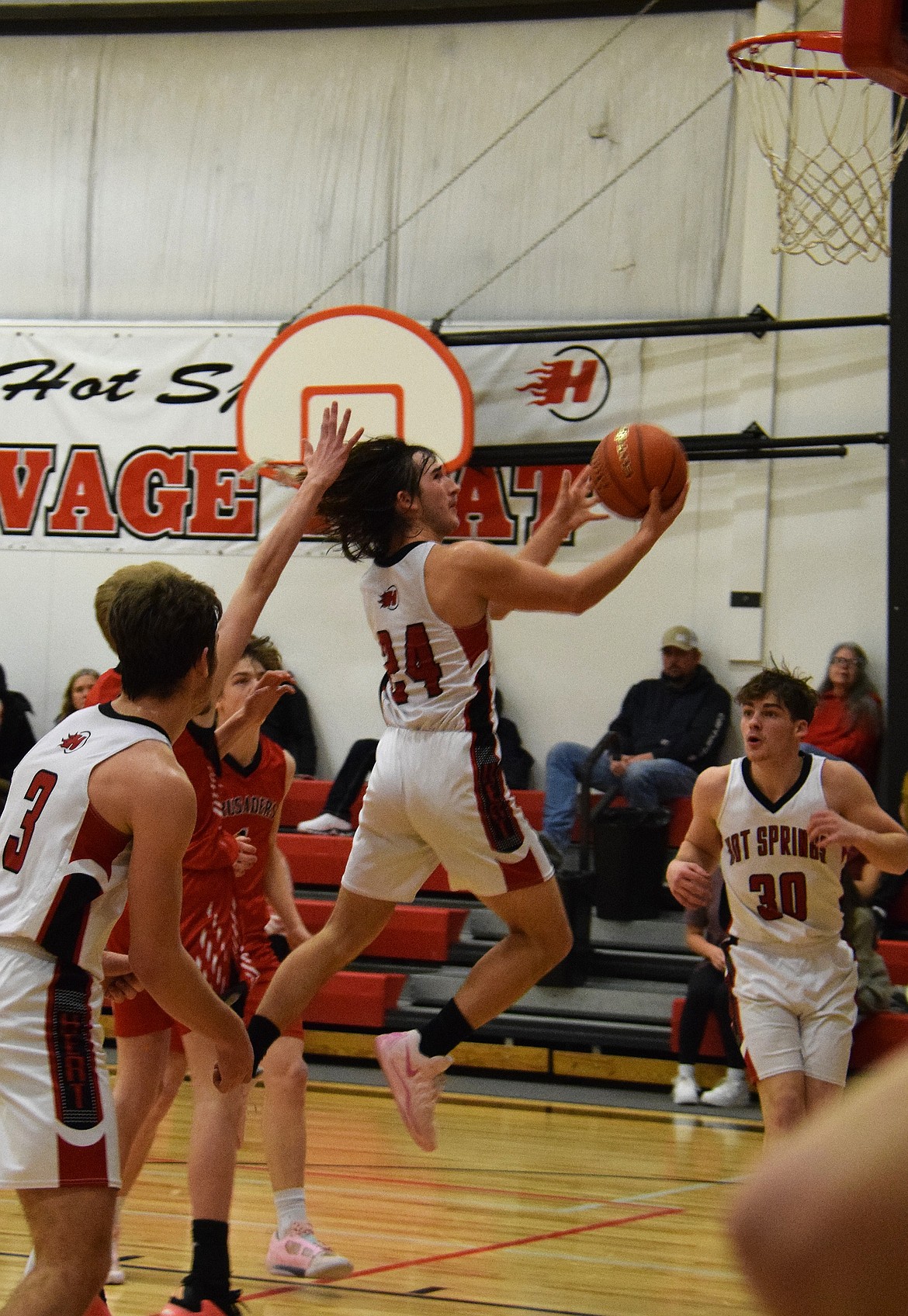 Hot Springs senior guard Weston Slonaker goes up for two during the Savage Heat's game this past week with Flathead Valley Home School in Hot Springs.  (Photo by Jen Christensen)