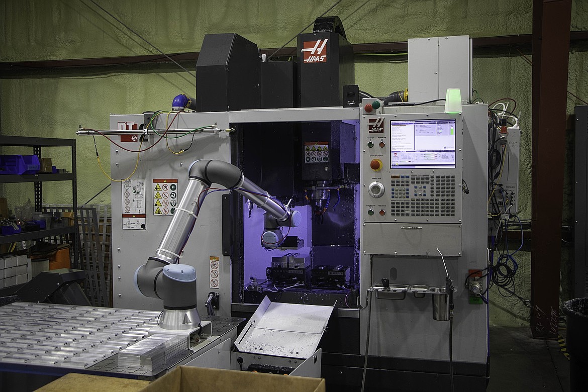 A three axis machine, with a robot arm, works on creating magazine extension parts on Jan. 28 at Shield Arms in Bigfork. (Kate Heston/Daily Inter Lake)