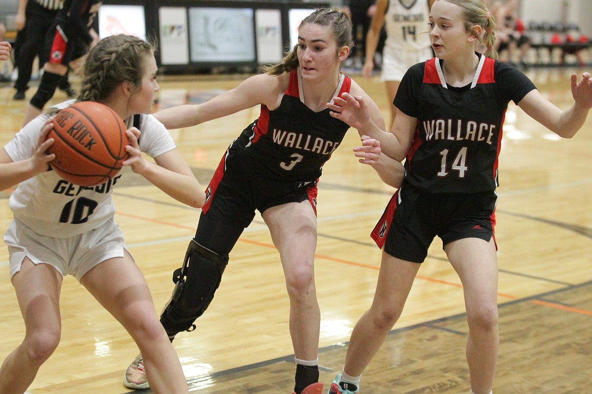 JASON ELLIOTT/Press
Wallace defenders Kylee Phillips (3) and Kayden Stutzke (14) attempt to trap Genesis Prep senior guard Ella Martin in the backcourt during the first quarter of Tuesday's 2A District 1 girls basketball game at Post Falls High.
