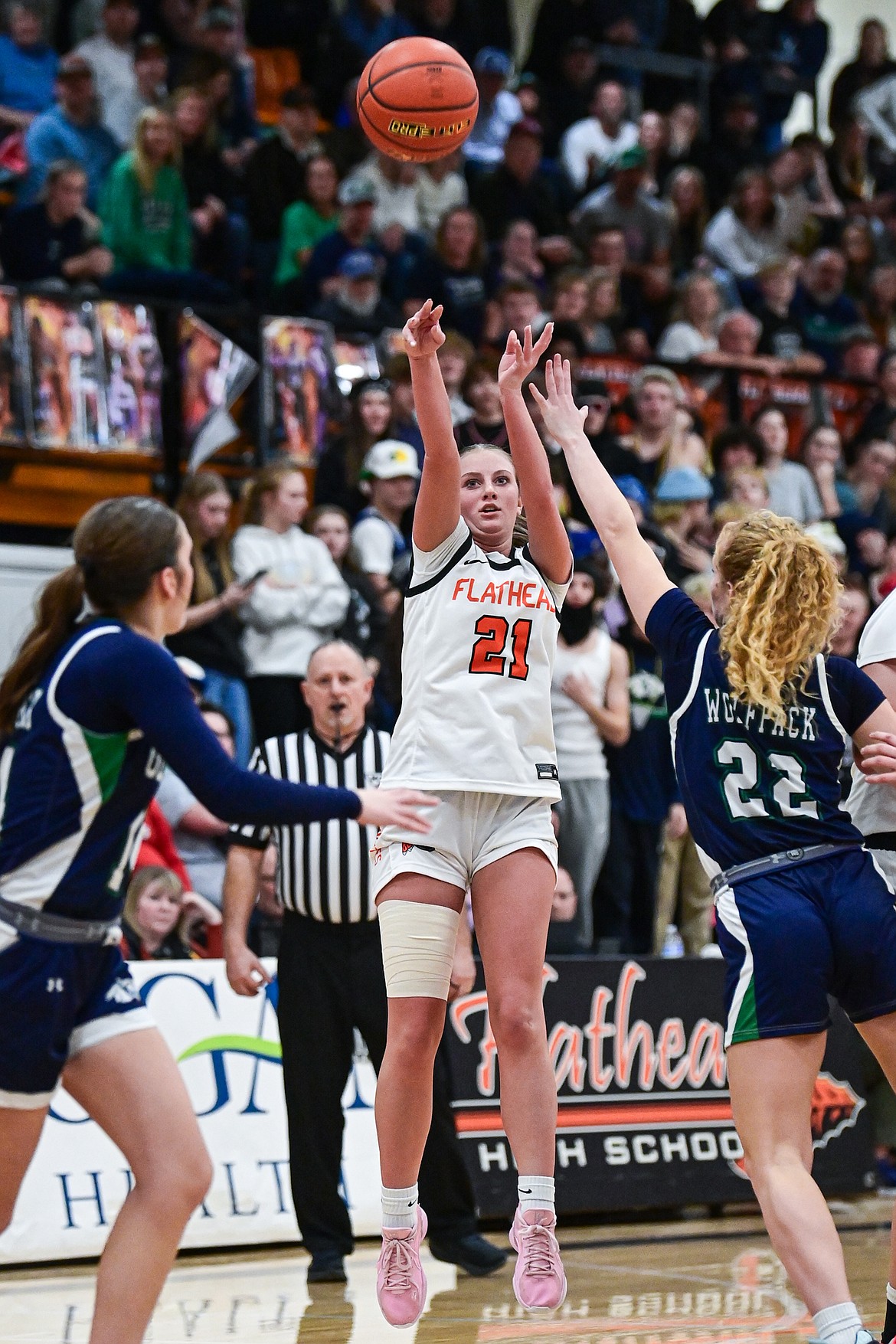 Flathead's Ava Malmin (21) knocks down a three in overtime against Glacier at Flathead High School on Thursday, Feb. 6. (Casey Kreider/Daily Inter Lake)