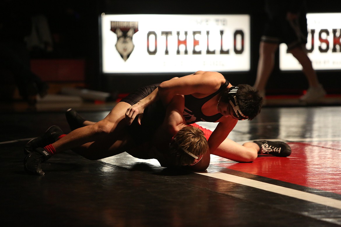 Othello sophomore Armoni Zuniga-Mendez, top, pins his opponent at 150 pounds. Zuniga-Mendez capped off a four-pin run for the Huskies to open Thursday’s dual against Prosser.