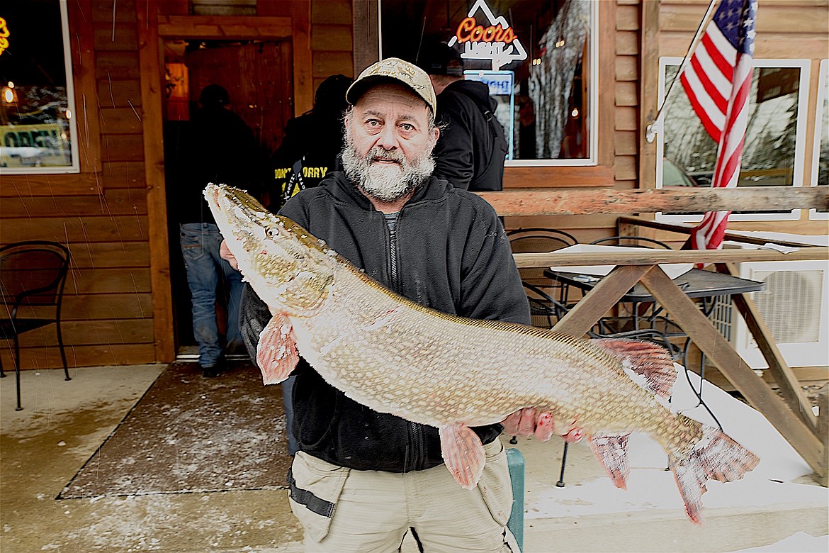 Libby’s Johnny Siefke shows off the big 18-pound, 9-ounce northern pike, he caught Saturday, Feb. 8, 2025, on Bull Lake during the Halfway House Bar and Grill Ice Fishing Derby. (Scott Shindledecker/The Western News)