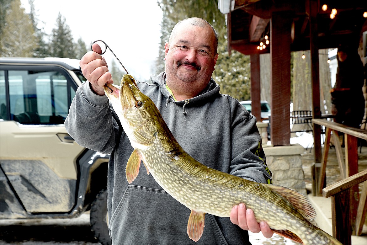 Libby's Vic Crace shows off a 7-pound, 6-ounce northern pike he hauled in Saturday during the Halfway House Bar and Grill Ice Fishing Derby. (Scott Shindledecker/The Western News)