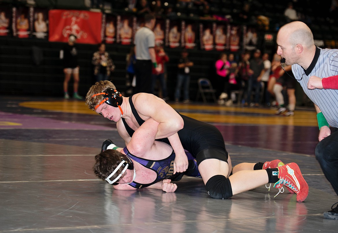 Plains-Hot Springs 190 pounder David Chapman (top), who finished second at the Western Divisional B-C meet in Butte this past weekend works for a pin.  (Photo by Teresa Waterbury