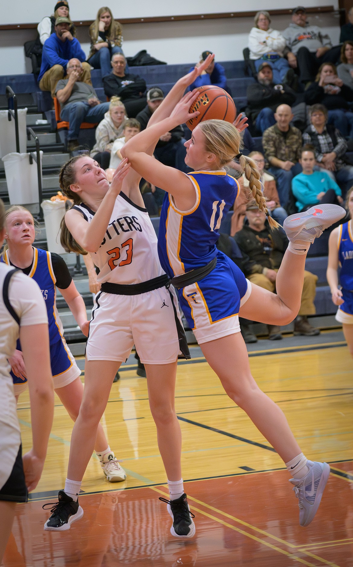 Thompson Falls junior forward Gabi Hannum puts up a shot over the outstretched arms of Trotters forward Taryn Meredith this past Thursday in Plains.  (Tracy Scott, Valley Press)