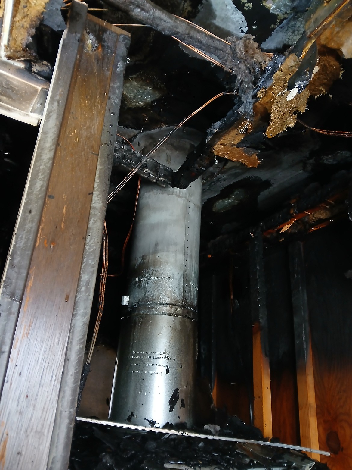 The ceiling had to be torn apart during a house fire in St. Regis on Sunday. The home was destroyed, but the family and their pet escaped safely. (Photo Kat Kittridge)