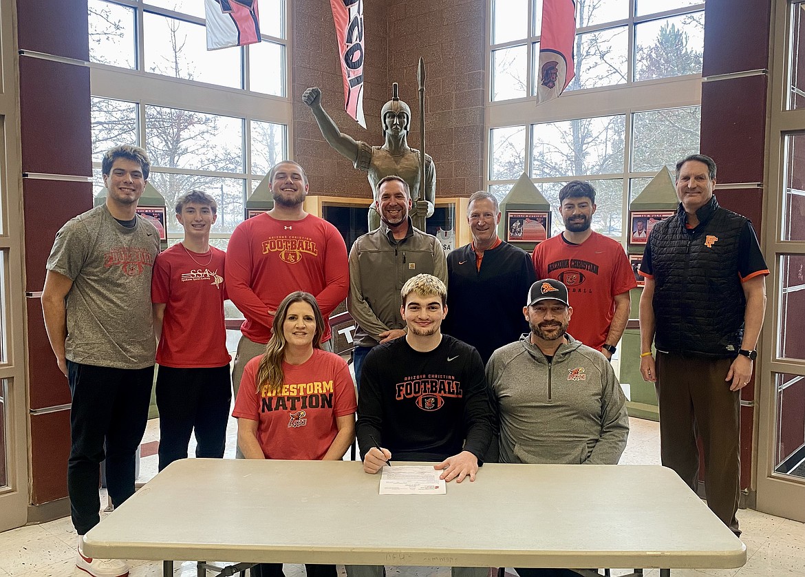 Courtesy photo
Post Falls High senior Isaac McKeown recently signed a letter of intent to play football at NAIA Arizona Christian University in Glendale, Ariz. Seated from left are  Shannon McKeown, Isaac McKeown and Mike McKeown; and standing from left, Tyras Blake, Cobe Cameron, Cooper Woydziak, Dan Pearse, Blaine Bennett, Junior McKeown and Craig Christensen.