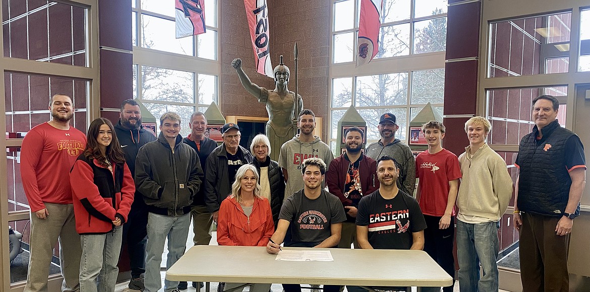 Courtesy photo
Post Falls High senior Tyras Blake recently signed a letter of intent to play football at Eastern Washington University. Seated from left are Allison Archer, Tyras Blake and Karmen Blake; and standing from left, Cooper Woydziak, Vanessa Kison, Adam Shamion, Isaac McKeown, Blaine Bennett, Steve Archer, Janice Archer, Elijah Blake, Kristian Blake, Mike McKeown, Cobe Cameron, Trenton McLean and Craig Christensen.