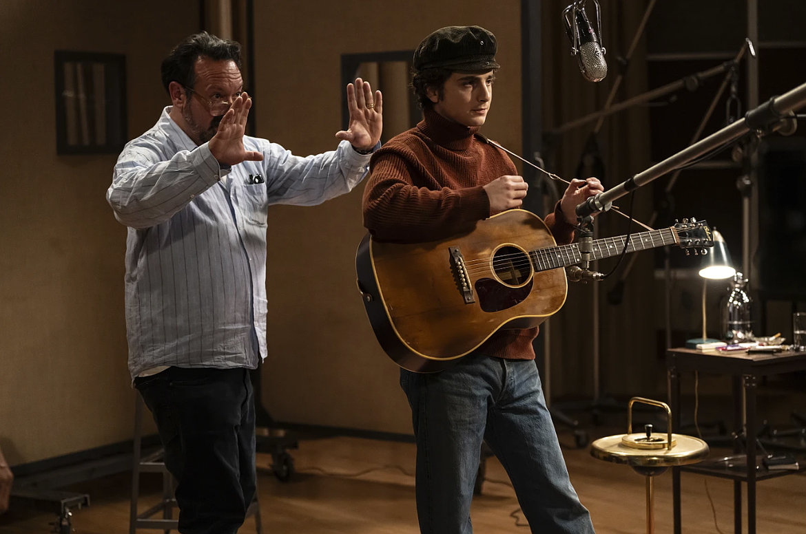 This image released by Searchlight Pictures shows director James Mangold, left, and Timothée Chalamet on the set of "A Complete Unknown."