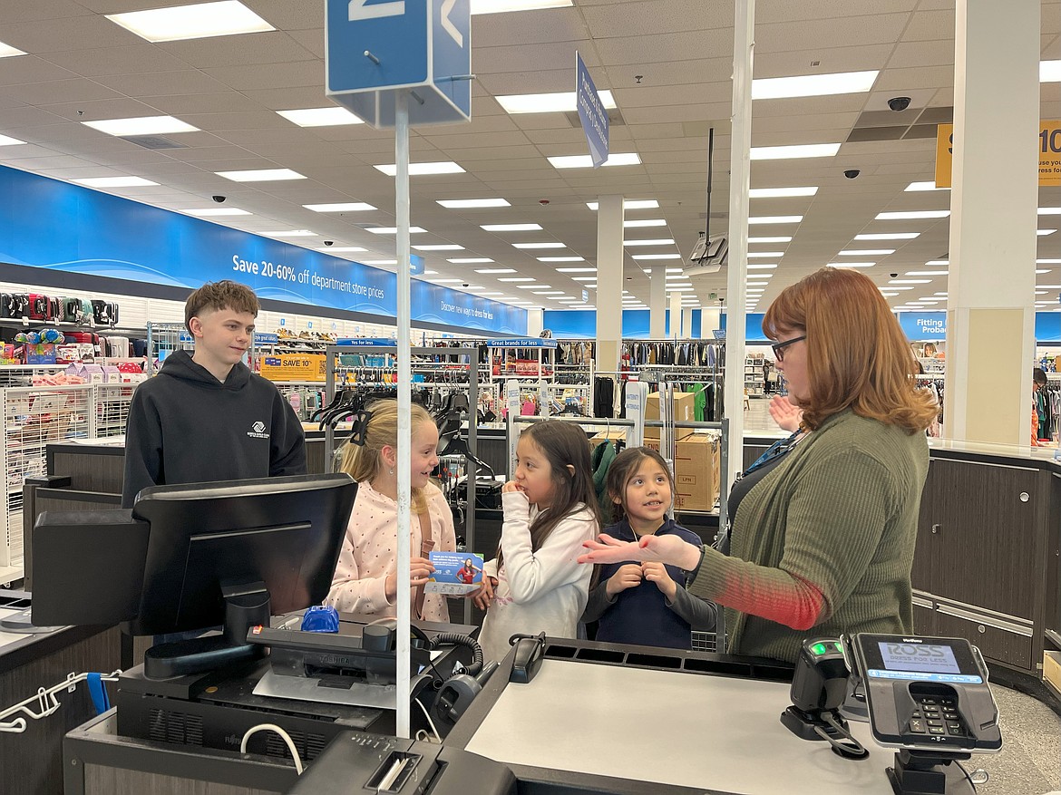 Children from the Boys and Girls Club visit with a Ross clerk in Moses Lake.