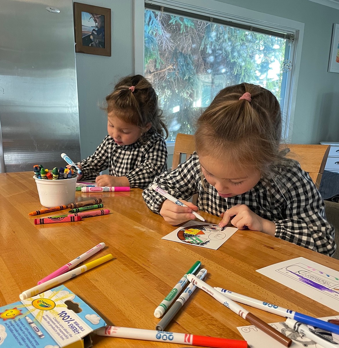 Poppy and Lily Uno fil out Kindness Cards from past years. This year's Kindness Cards will be distributed the first week of March.