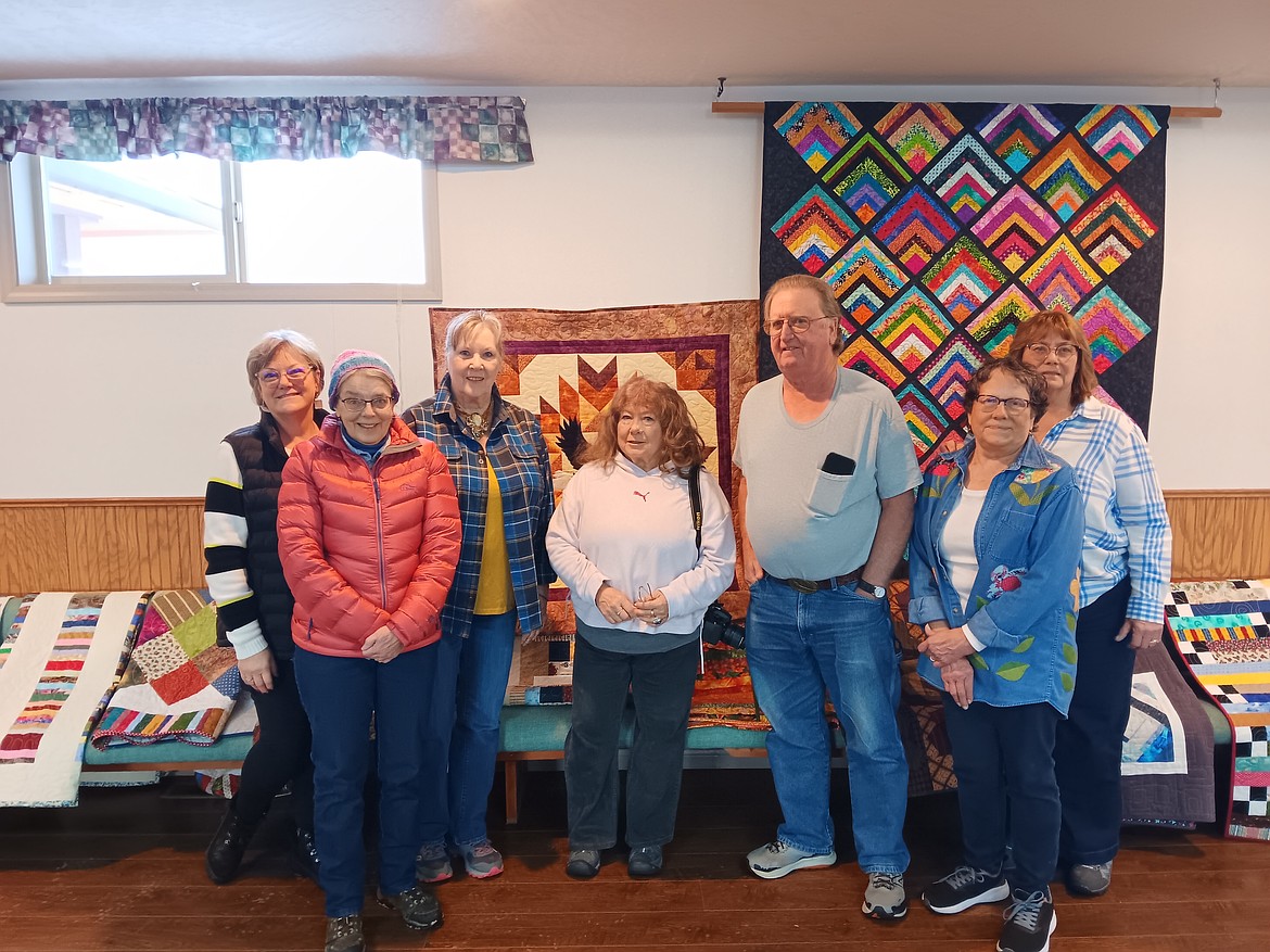 The Cabin Fever Quilters Guild is giving veterans in Mineral County a handmade quilt to thank them for their service. From left, Paula Dalby, Bonnie Goodrich, Della Russell, Nicki Clyde, Daniel Kulawinski, Margaret Olson, Sandra Allen stand with the quilts inside the St. Regis Community Center on Saturday, Feb. 15. Kulawinski served in the Air Force as a security policeman from 1977 to 1980. (Monte Turner/Mineral Independent)