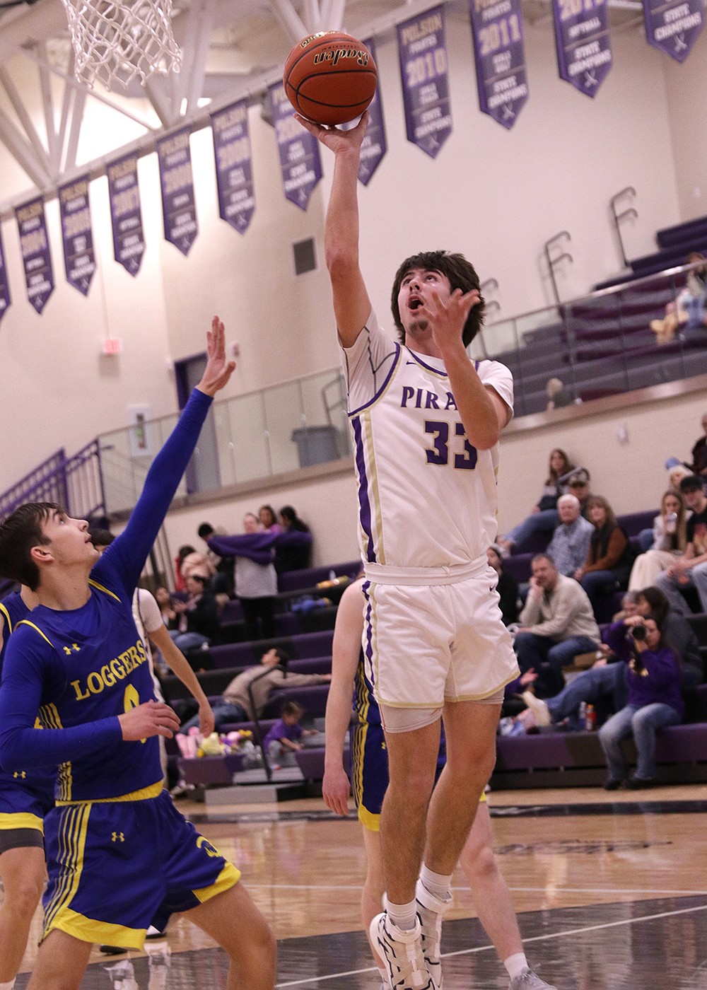 Polson senior Cason Graham celebrates Senior Night last Saturday with a lay-up against Libby. (Bob Gunderson photo)