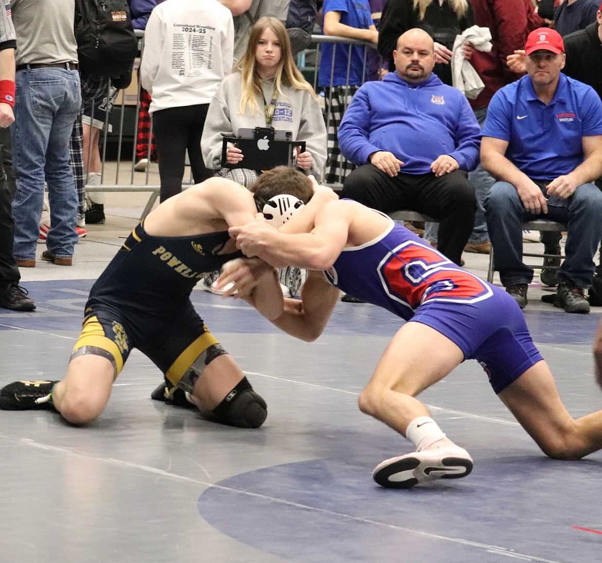 Superior's Turner Milender (Blue, right) wrestling at 157 pounds just before he was injured at the Western Divisional Tournament in Butte this past weekend.  (Photo by Kami Milender)