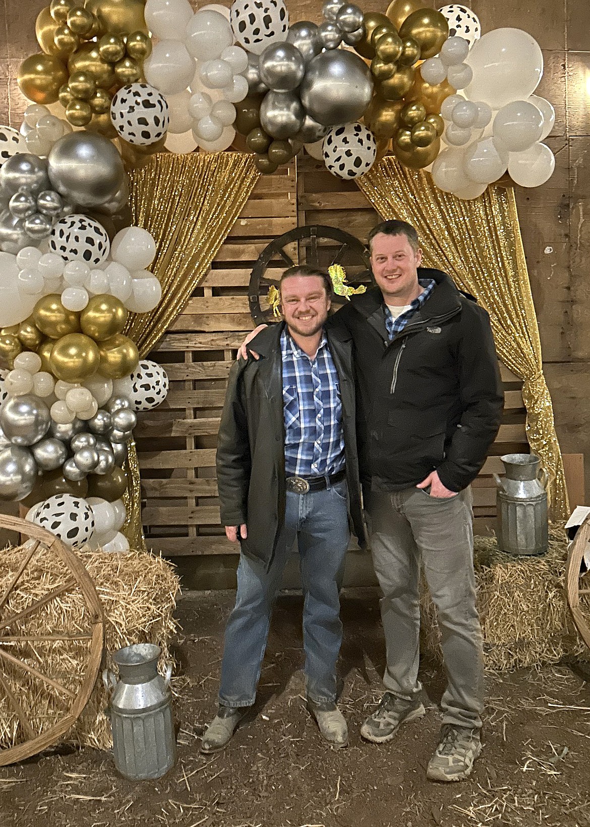 Sven Leland’s brothers Lars, left, and Martin Leland take a photo in the homemade photo booth at the Sven Legacy Foundation’s auction Saturday.