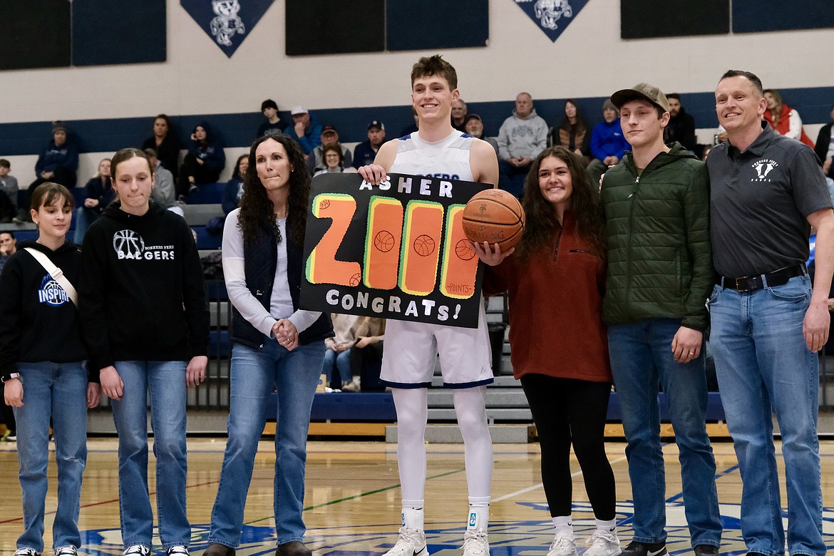 The Williams family stands at midcourt during a pregame recognition for Asher William's 2,000 career points.