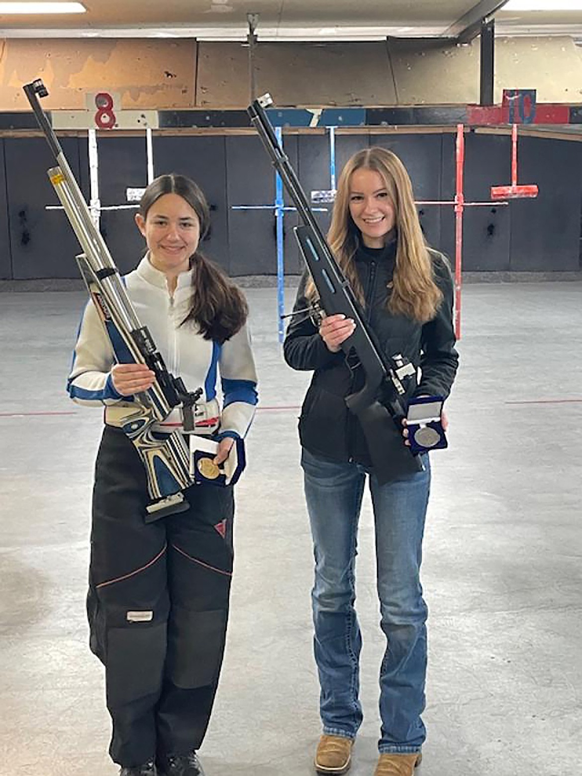 Kyalynn Comer and Ethnee White pose for a photo after the junior rifle match held Saturday, Feb. 15, at the Kootenai Valley Range.