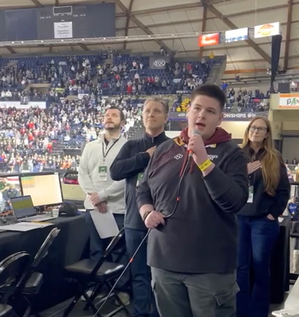 Moses Lake junior Masen Meek sings the national anthem to begin the Mat Classic wrestling tournament in Tacoma Thursday.