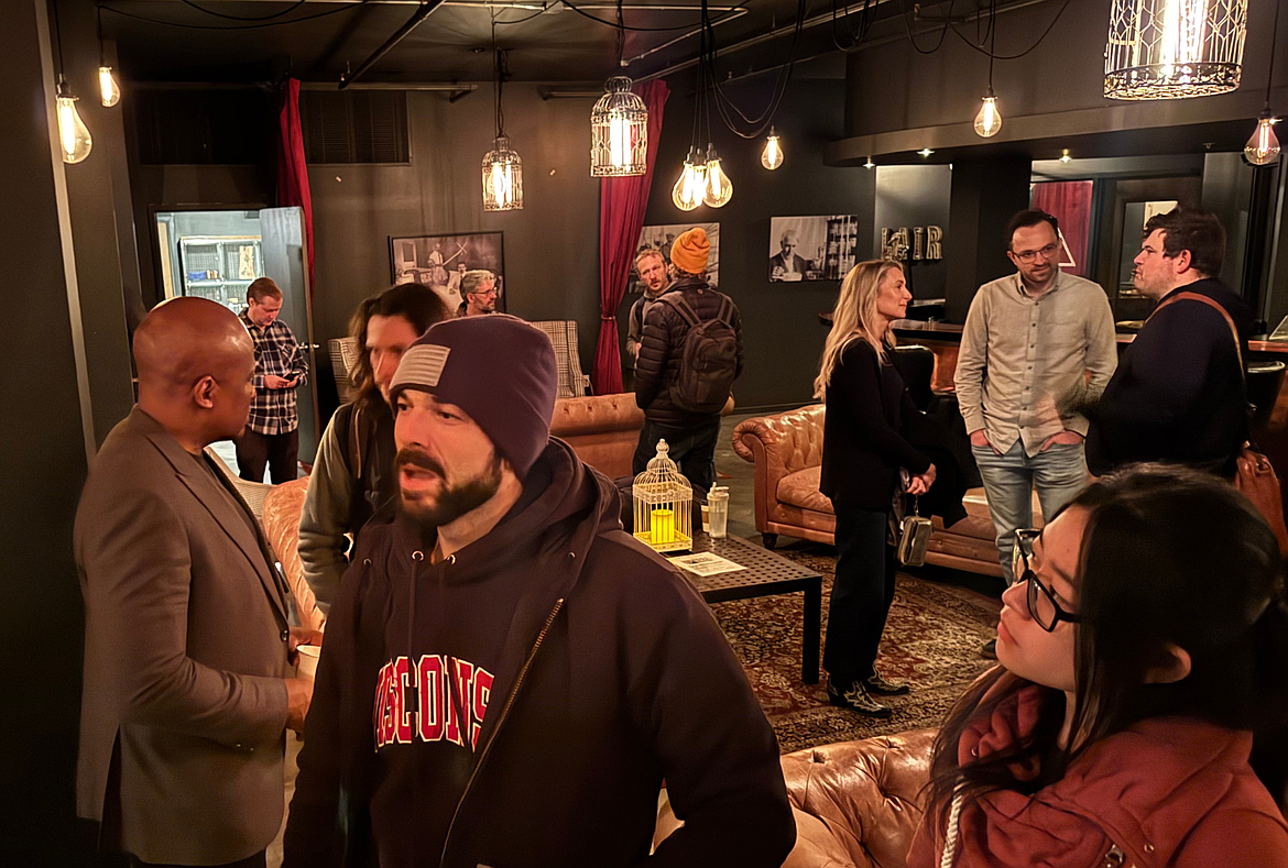 Luke Dupin, co-founder of Wonk, is seen in the background during a weekly AI event with other build_ members working on AI companies.