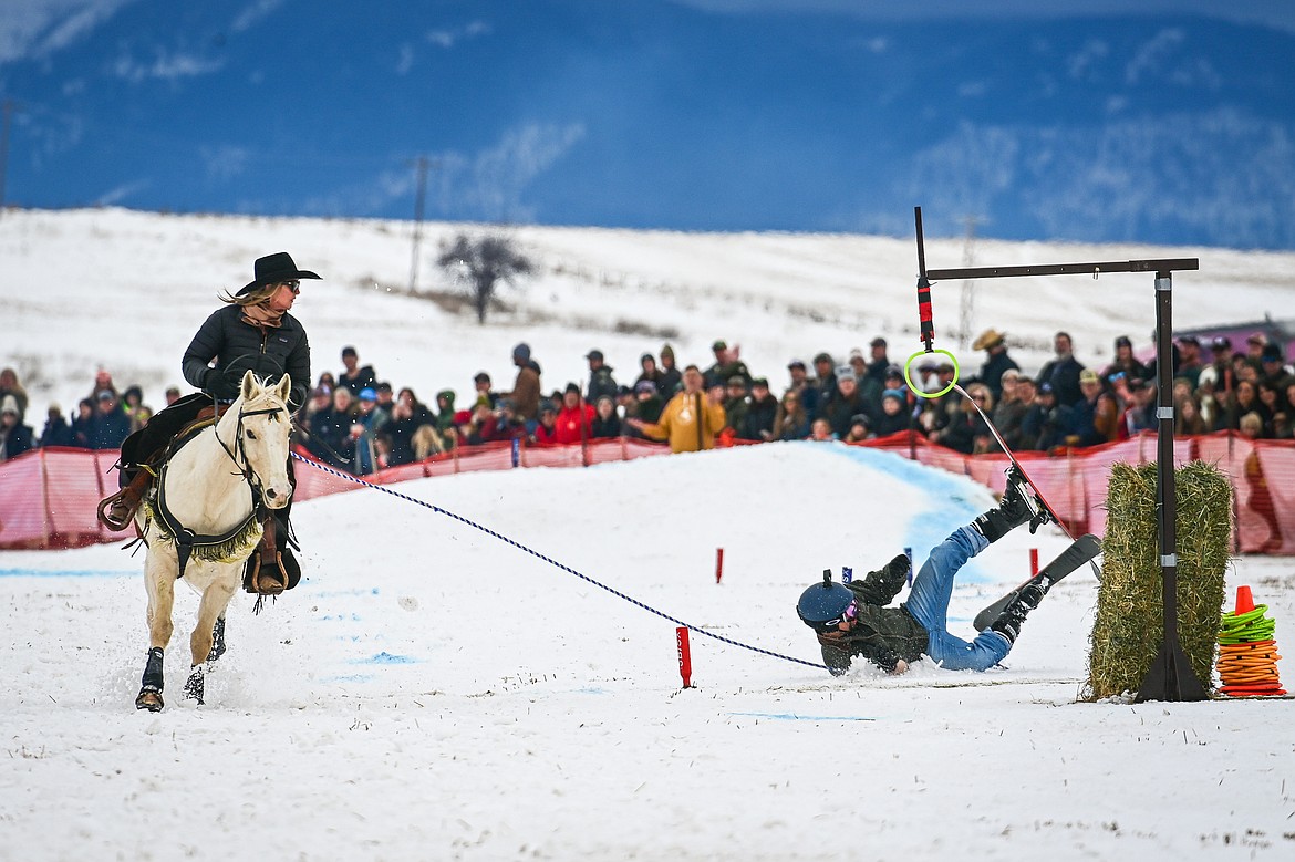 A skier crashes on the course at Whitefish Skijoring on West Springcreek Road on Saturday, Feb. 22. (Casey Kreider/Daily Inter Lake)
