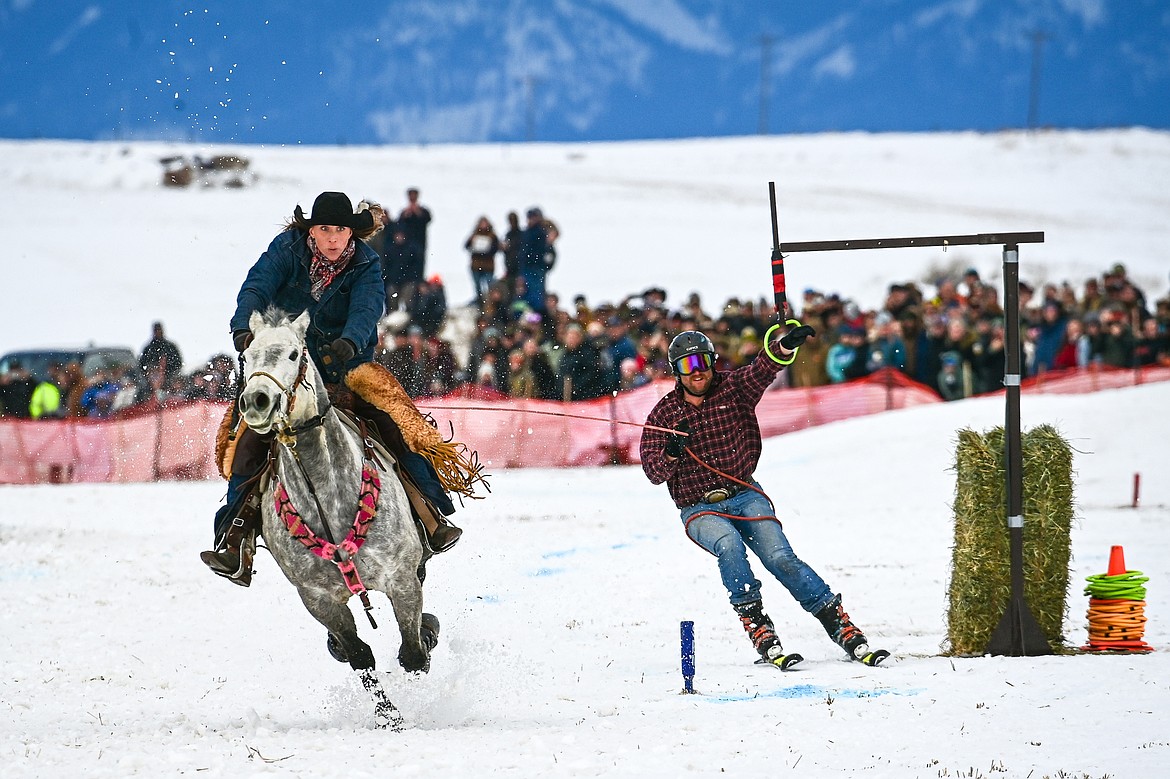 A skier secures a ring as he's pulled through the course at Whitefish Skijoring on West Springcreek Road on Saturday, Feb. 22. (Casey Kreider/Daily Inter Lake)
