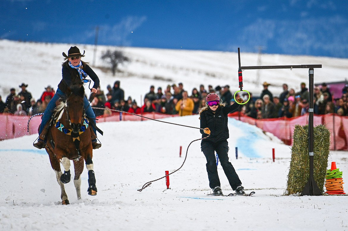 A skier secures a ring as he's pulled through the course at Whitefish Skijoring on West Springcreek Road on Saturday, Feb. 22. (Casey Kreider/Daily Inter Lake)
