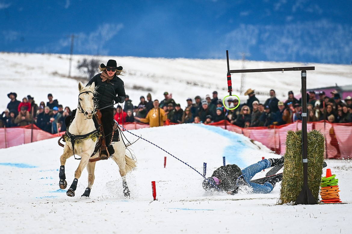 A skier crashes on the course at Whitefish Skijoring on West Springcreek Road on Saturday, Feb. 22. (Casey Kreider/Daily Inter Lake)