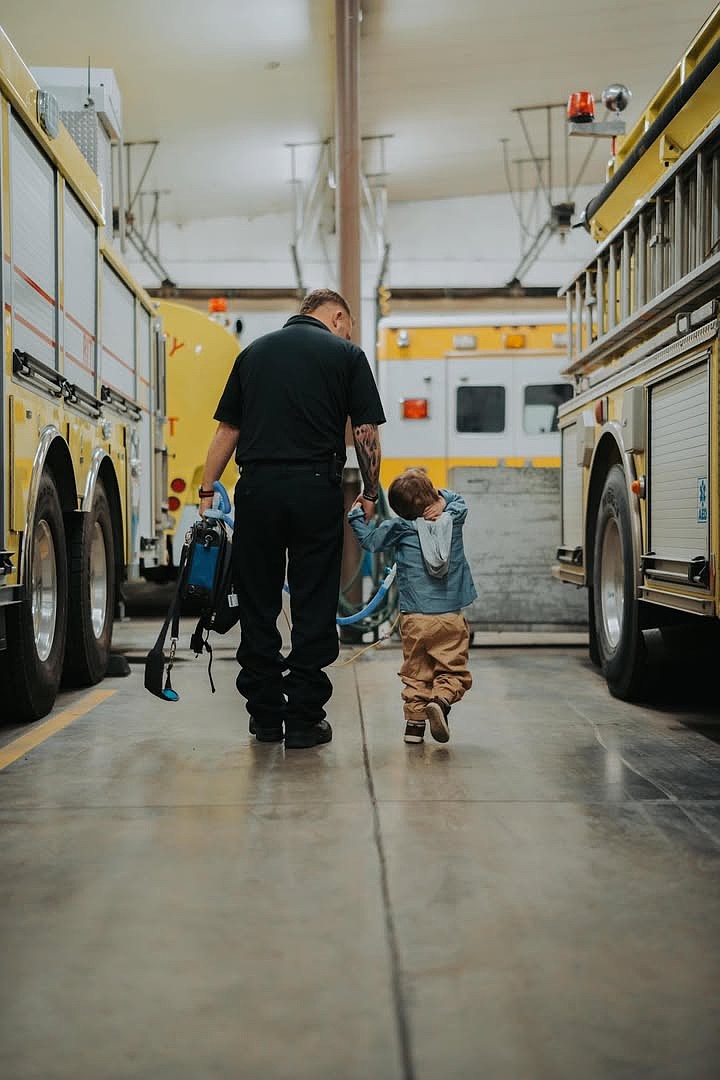 Travis Svilar and Preston Thomas take a stroll around the fire station during a Friday afternoon visit to the fire station.