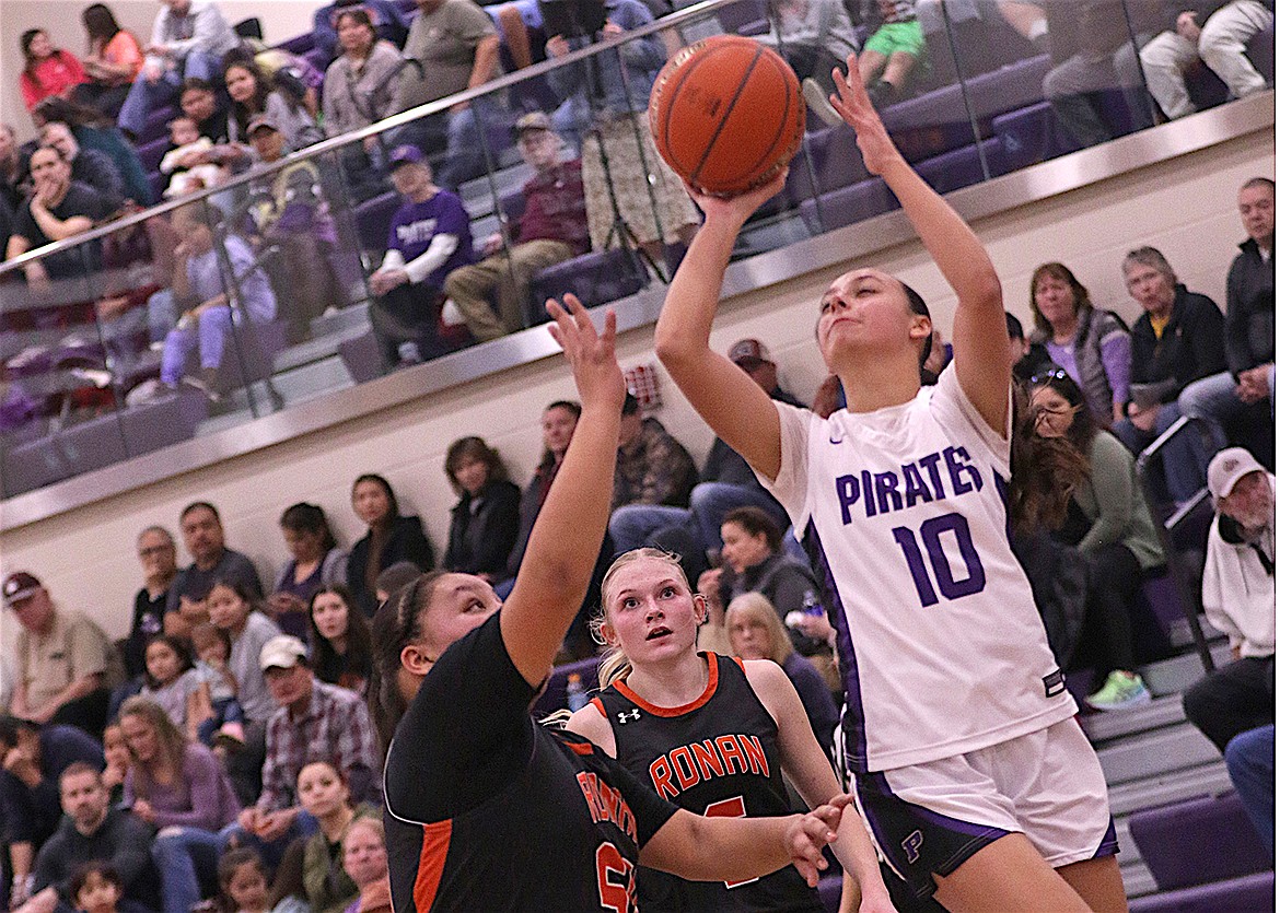 Polson's Samantha Rensvold goes up for two against Maidens Nevaeh Perez and Lauryn Buhr last Saturday in Polson. The Ronan team won the close-fought contest by seven points. (Bob Gunderson photo)