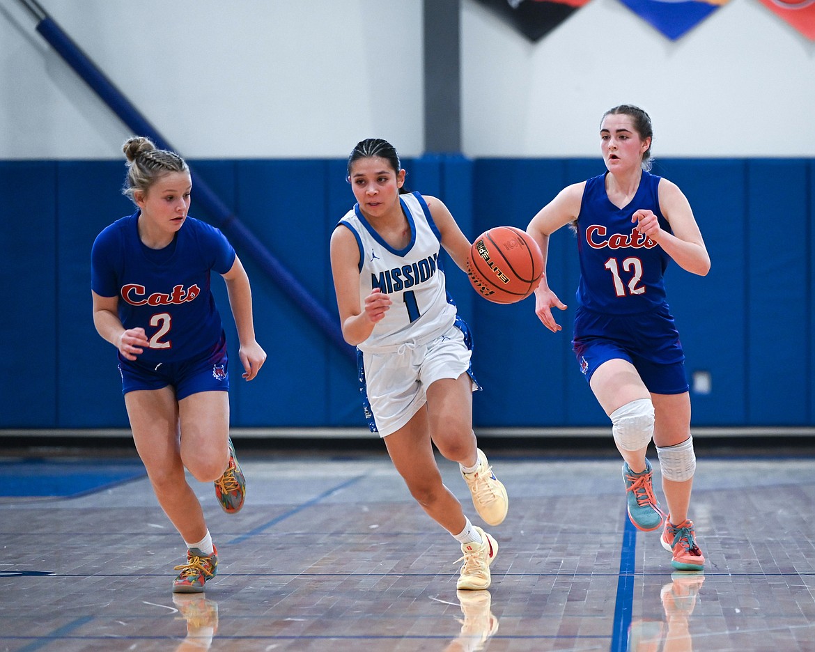 Mission's Kason Page outpaces the Superior Bobcats during District 7B tournament action last Friday. Page contributed 17 points to the final score of 62-13; the Lady Bulldogs went on to beat Thompson Falls for the district title. (Christa Umphrey photo)