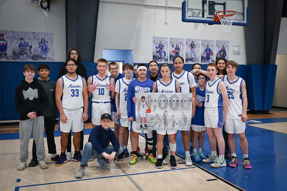 Lex LaFrombois celebrates topping 1,000 points in his high school career, alongside the rest of the Mission Bulldogs, following Saturday's win against Superior (Christa Umphrey photo)