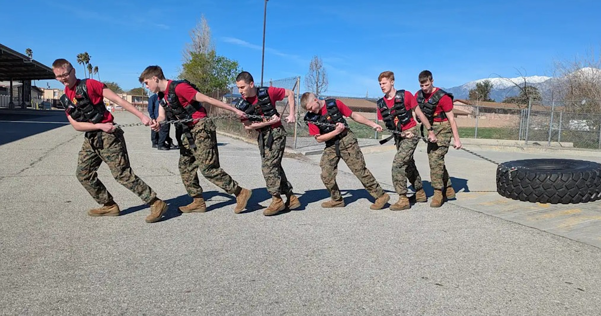 Members of Kellogg High School's Marine Corps JROTC Raider team work together to pull a heavy tire during their recent competition at Fontana High School in Fontana, California.