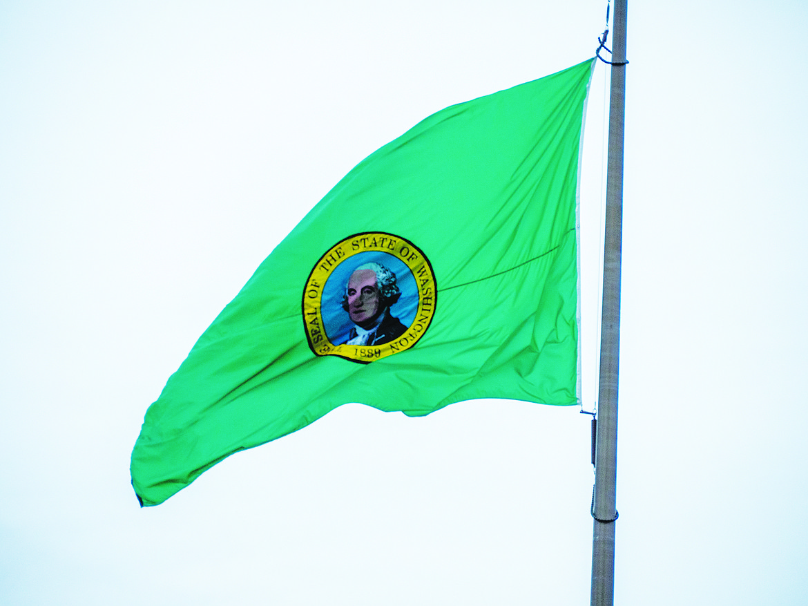 The Washington state flag waves in the wind at the state capitol on Feb. 18. Designed in 1914 by the Daughters of the American Revolution, led by Emma Chadwick, the flag was adopted on March 5, 1914.