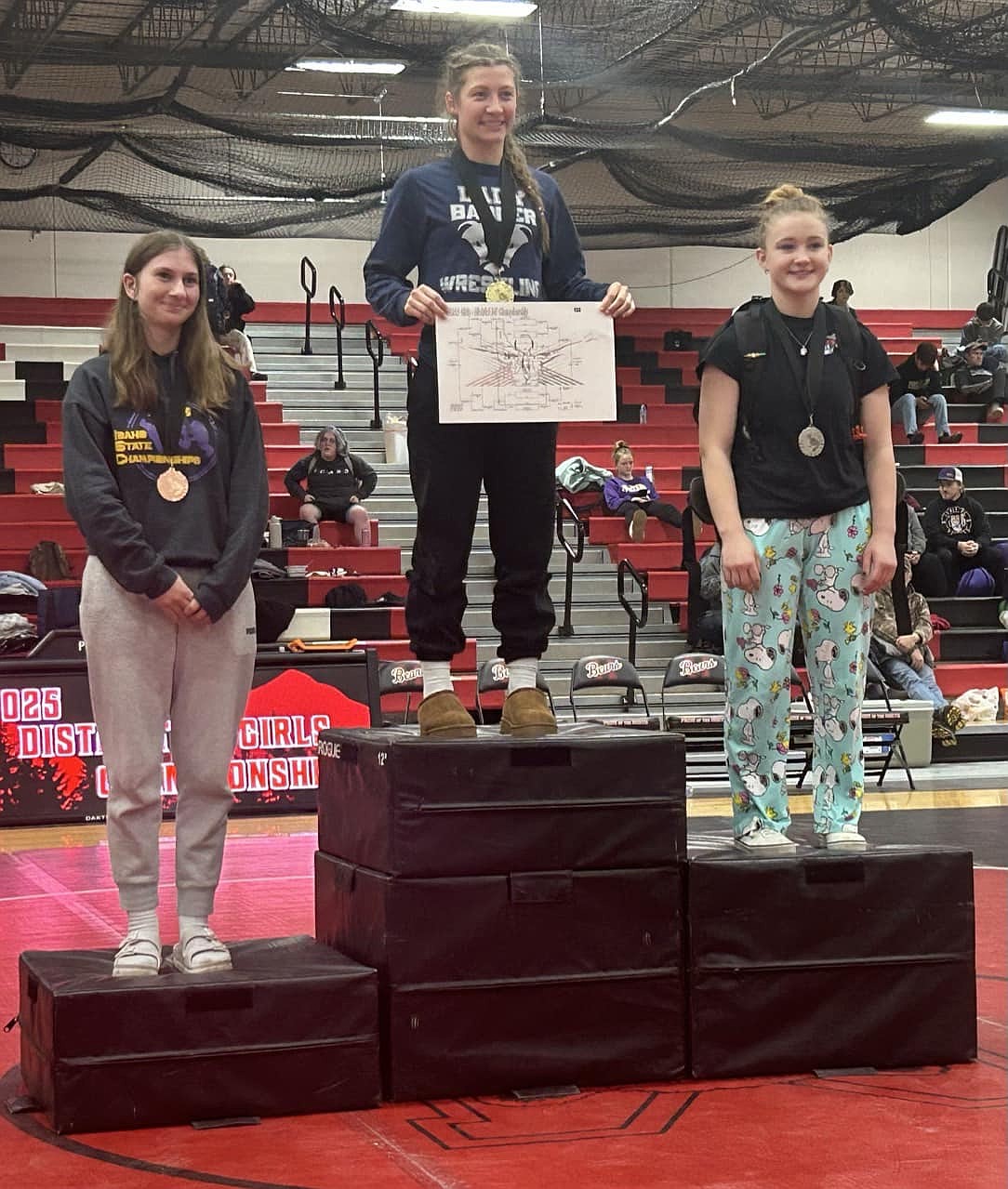 Bonners Ferry High senior Sofia Brown stands atop of the podium after winning the 138-pound weight class at the All-Class District 1-2 tournament held this past Wednesday, Feb. 19 at Moscow High.