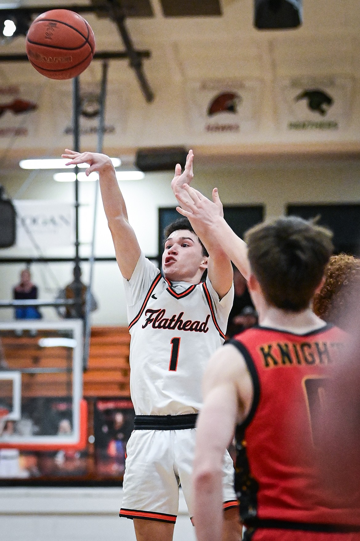 Flathead's Dustyn Franchini-White (1) hits the game-winning three-pointer at the buzzer to beat Missoula Hellgate 42-40 at Flathead High School on Thursday, Feb. 27. (Casey Kreider/Daily Inter Lake)