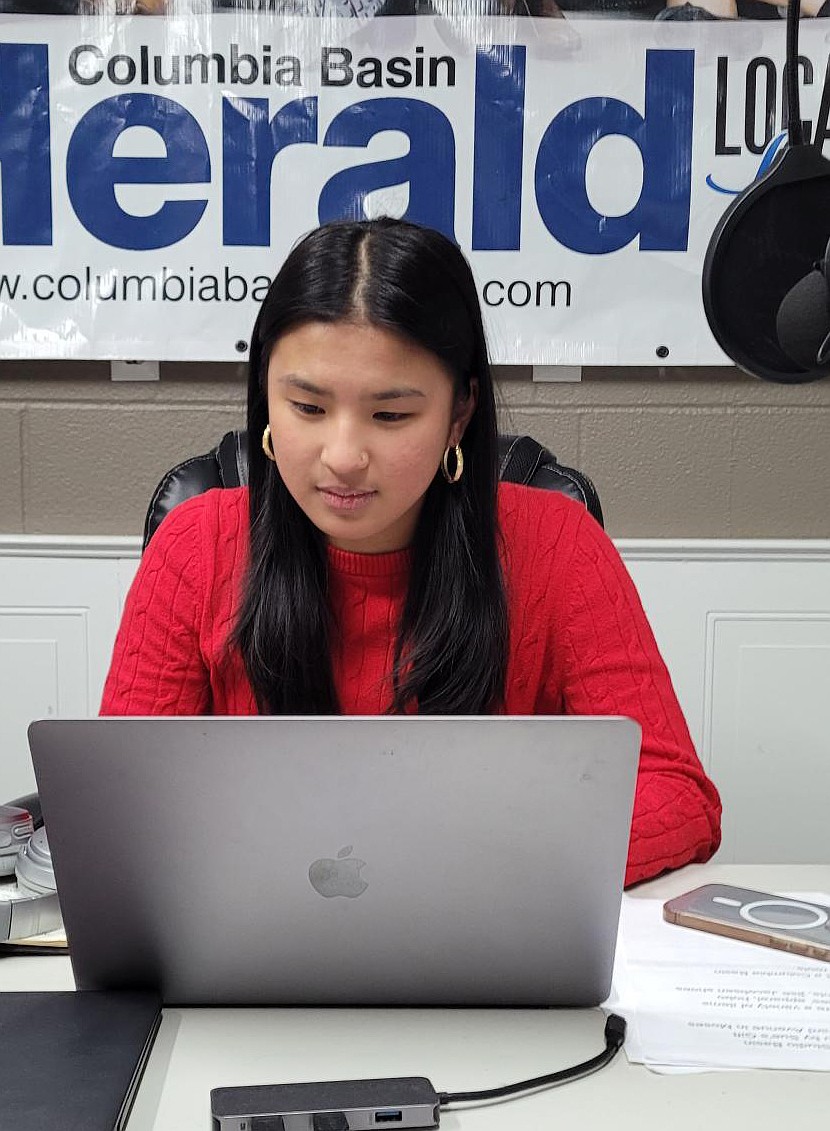 Columbia Basin Herald intern Elizah Lourdes Rendorio works on a story in the Columbia Basin Herald’s office. She can more often be found at the state Capitol covering the legislative session.