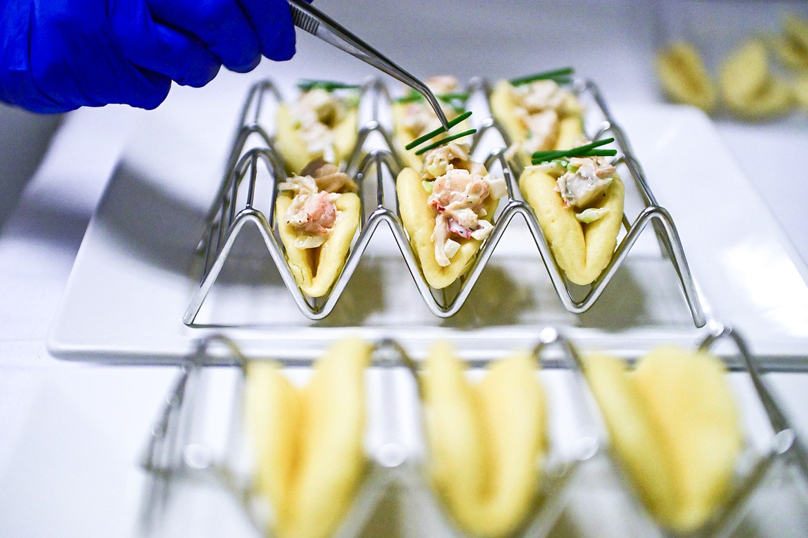 Max Malcomson garnishes lobster rolls served on bao buns as an amuse-bouche at a Chef's Table dinner series held by Flathead Valley Community College's Culinary Institue of Montana on Friday, Feb. 21. (Casey Kreider/Daily Inter Lake)