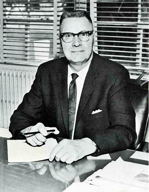 Perry A. Christianson posed for this North Idaho College photo circa 1968 while working at his desk in Lee Hall. Christianson taught math and chemistry, coached basketball, and was Dean of the College before becoming the fourth president in the history of the junior college in 1962.