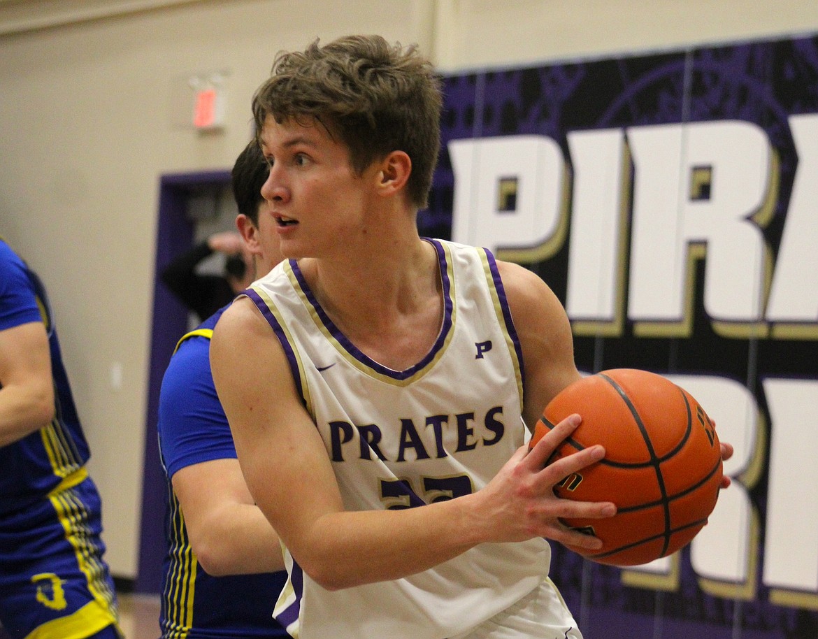 Polson's Maddox Bird looks to pass to a teammate after grabbing a rebound against Libby. (Kaleb Unger/Leader)