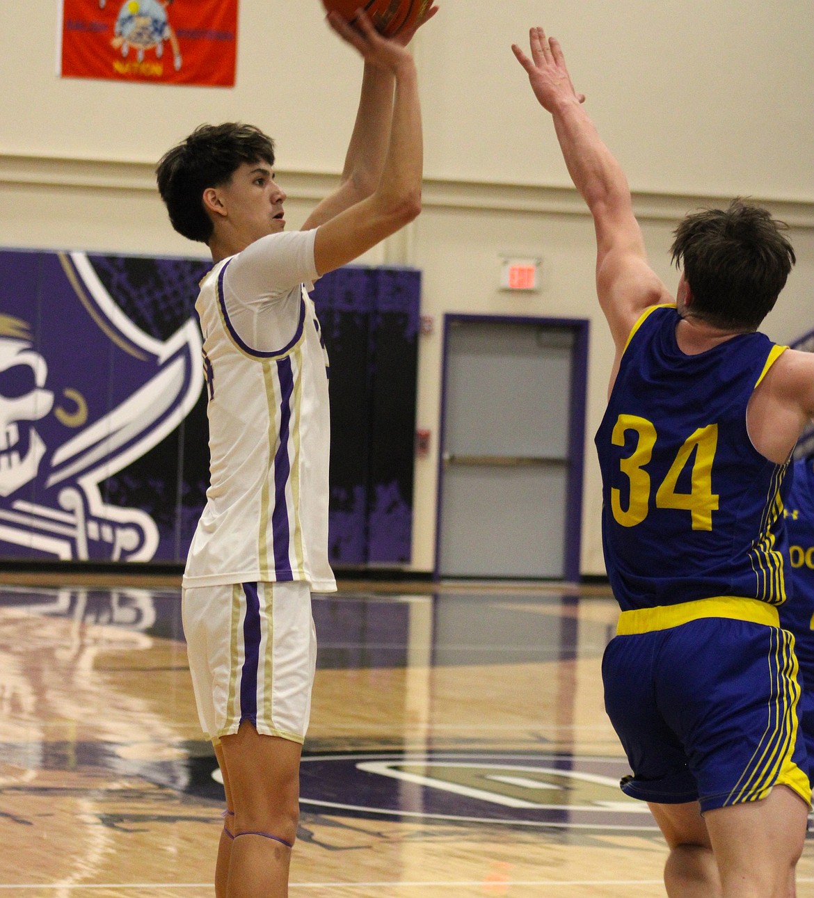 Polson's Malakai Curley shoots a three-pointer over a Libby defender. (Kaleb Unger/Leader)