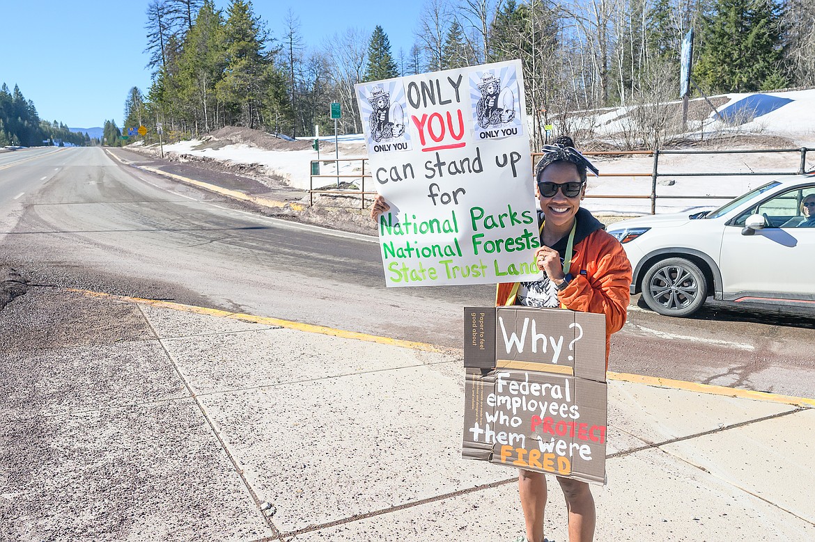 Kellie Ileto ralies for public lands at the intersection of Highway 2 and the Going-to-the-Sun Road Saturday.