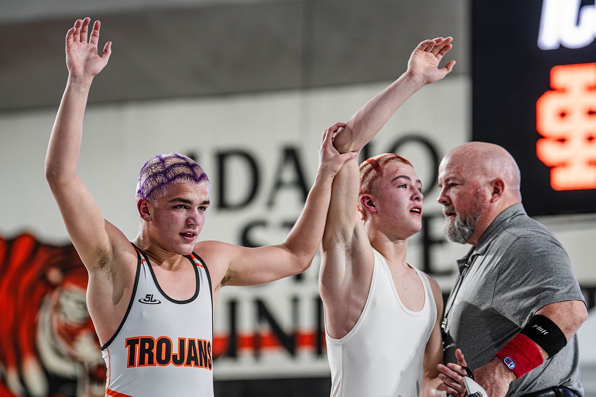Photo by JOLEN HOLLINGSWORTH
Matthew Hamilton, left, of Post Falls, and his teammate, runner-up Ryker Allen, both have their arms raised after Hamilton won their 6A 113-pound championship match Saturday at the ICCU Dome in Pocatello.
