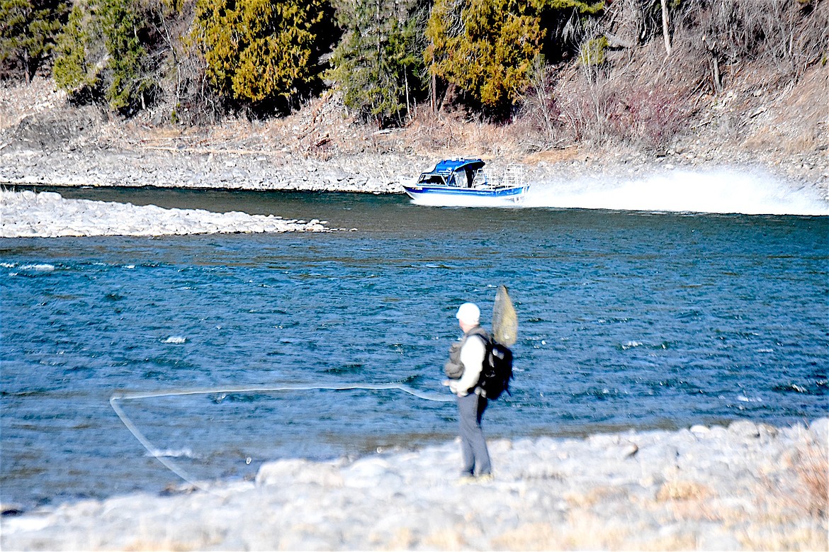 A fly fisherman takes a long look at a power boater after it roared up and down the Kootenai River Sunday, March 2, 2025, near the Yaak River Campground boat launch. (Scott Shindledecker/The Western News)