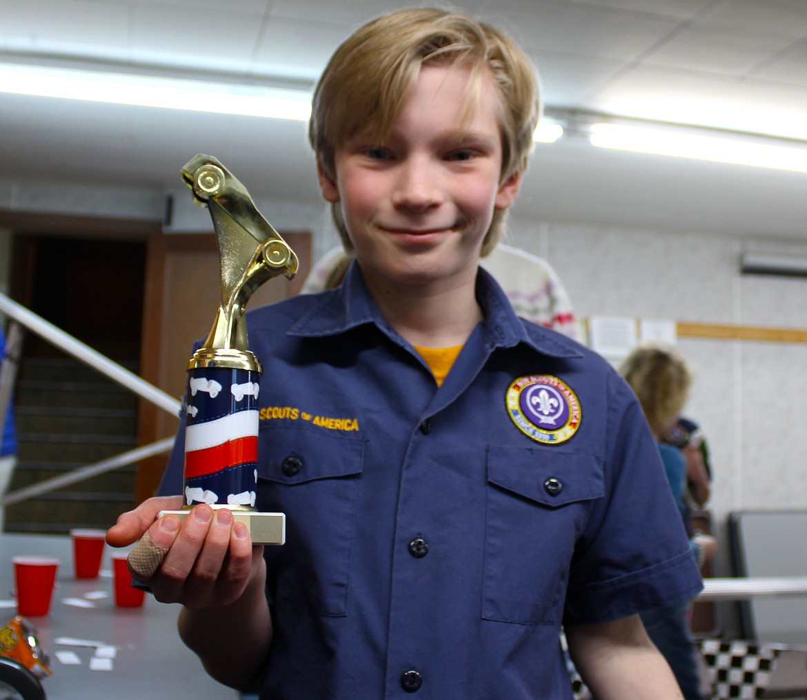 Pinewood Derby champion Brody Haines holds up his trophy. (Kaleb Unger/Leader)