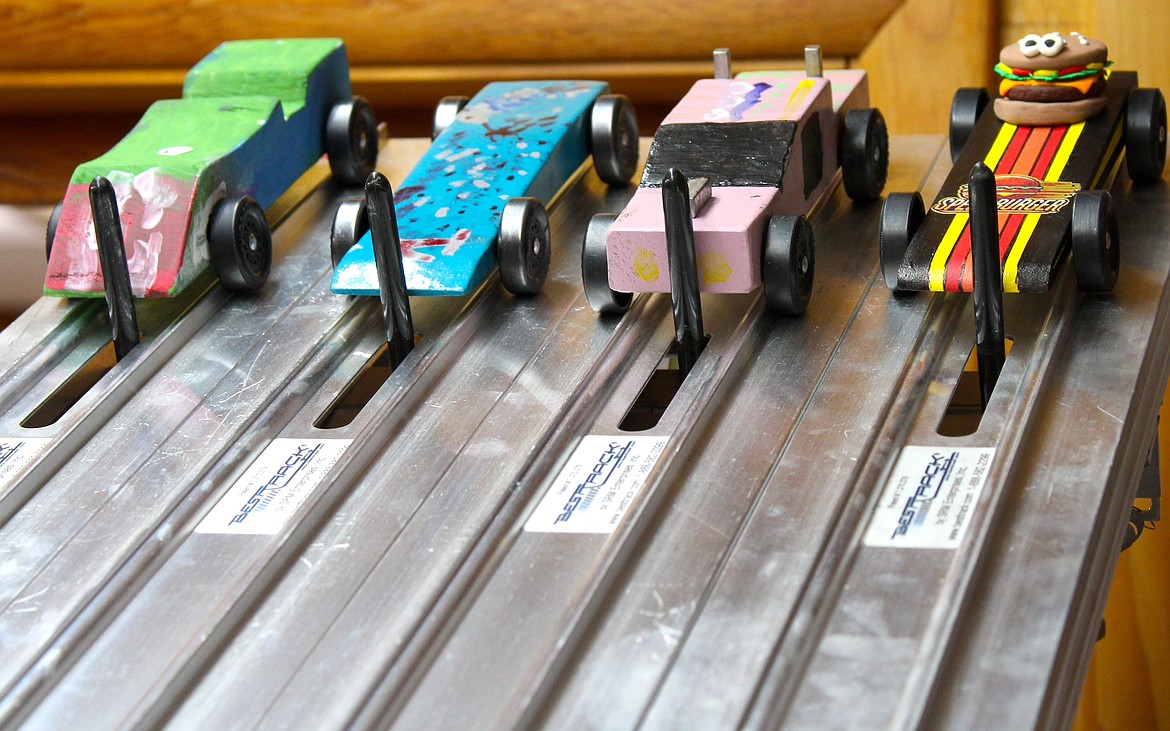 Cars from the Pinewood Derby sit still waiting to be released. (Kaleb Unger/Leader)