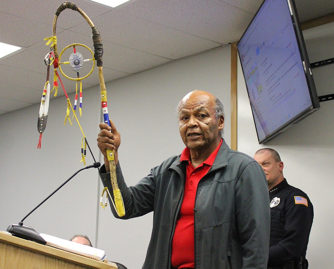 Ken Camel shows the Coup Stick to the City Commission audience. (Kaleb Unger/Leader)