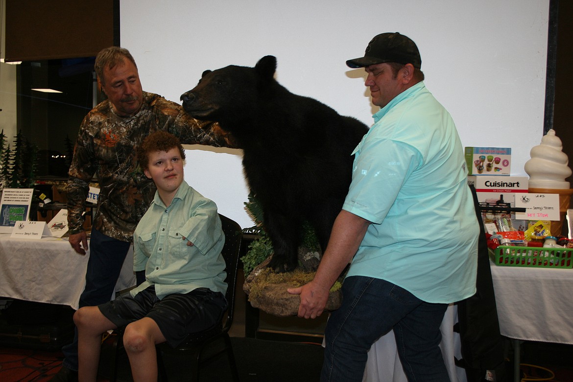 A bear trophy bagged on a Youth Outdoors Unlimited hunt is presented to its hunter at a previous Y.O.U. auction.