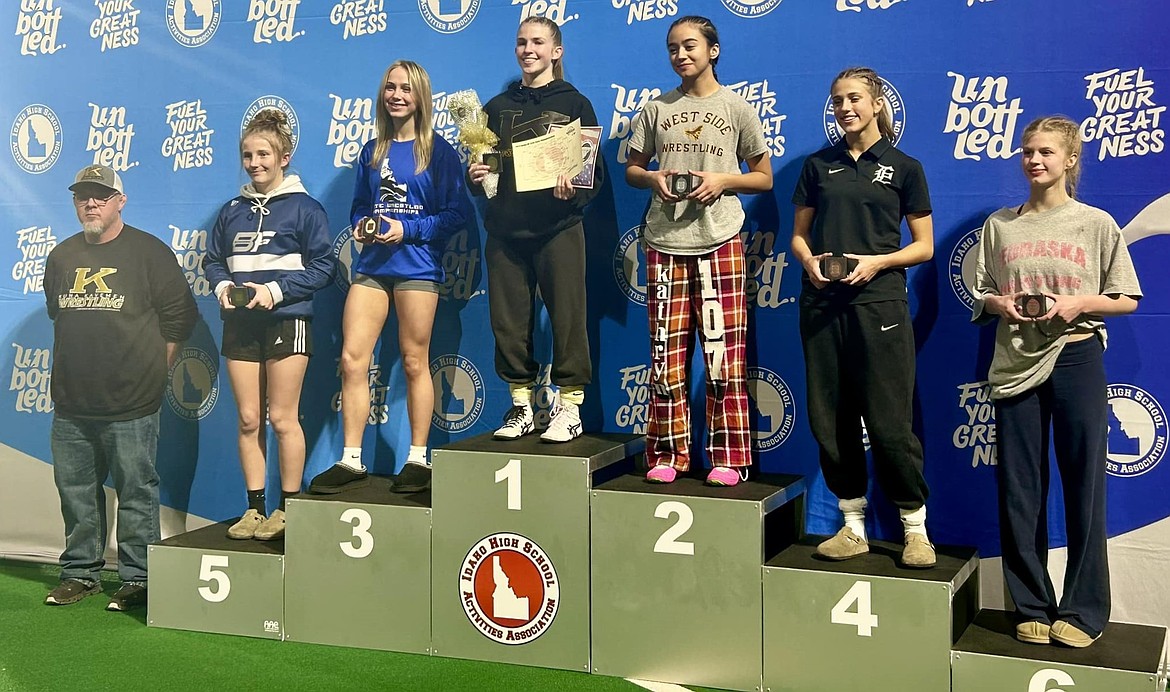 Bonners Ferry High sophomore Neveah Therrien, second from right, shows off the fifth-place medal she earned in the 107-pound weight class at the All-Class State Championship held Friday and Saturday at the ICCU Dome in Pocatello.