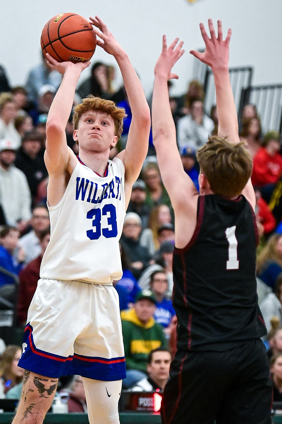 Columbia Falls' Grady Hutton (33) knocks down a three in the first half against Butte Central at the Western A Divisional Tournament at Whitefish High School on Thursday, March 6. (Casey Kreider/Daily Inter Lake)