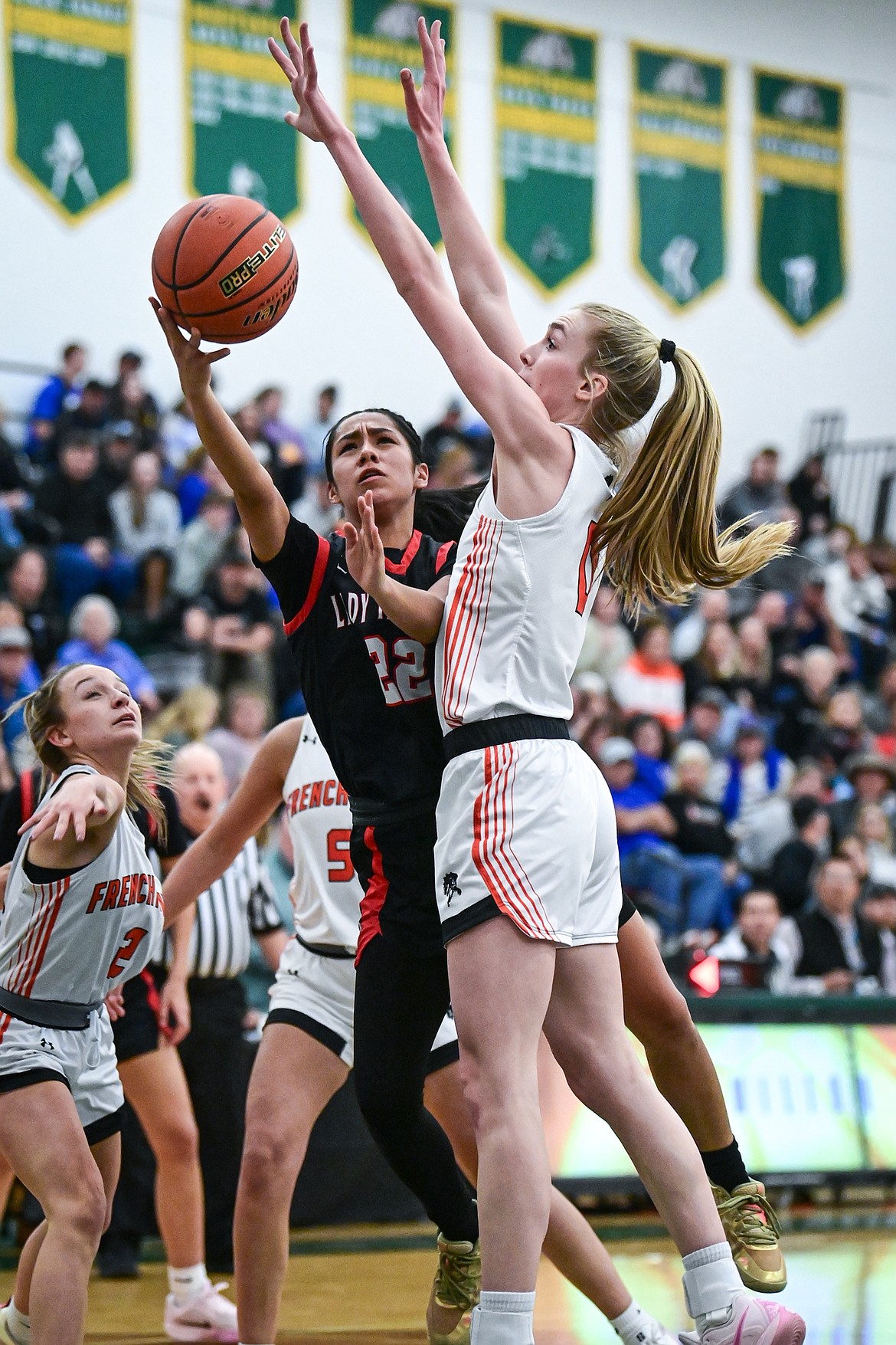 Frenchtown's Mason Quinn (0) blocks a shot by Browning's Amani YellowOwl (22) in the second half at the Western A Divisional Tournament at Whitefish High School on Thursday, March 6. (Casey Kreider/Daily Inter Lake)